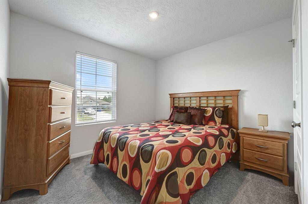 Last cozy secondary bedroom features a bright window, neutral walls, and plush carpeting. Ample space for bedroom furniture and/or toy room or work space.