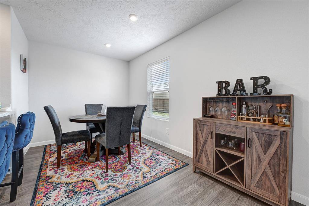 This cozy dining area features a space for breakfast table and coffee bar, natural light streams through, enhancing the room’s inviting atmosphere.