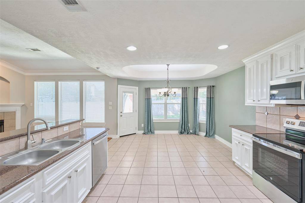 Walls of windows bring in the natural light. dining room is open to the kitchen & living room.