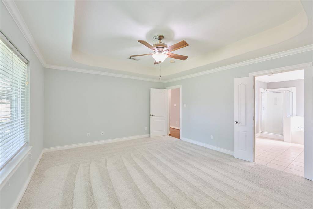 Primary suiite boasts double doors to executive bath