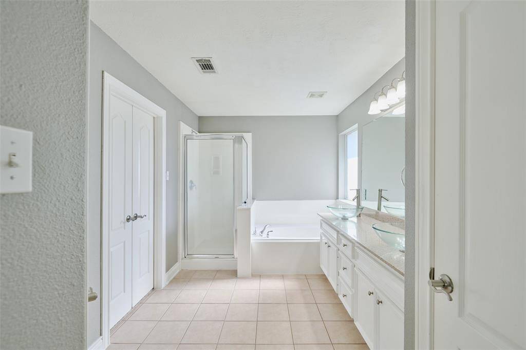 The primary bath features Dual sinks, linen closet, tub, separate shower & walk in closet