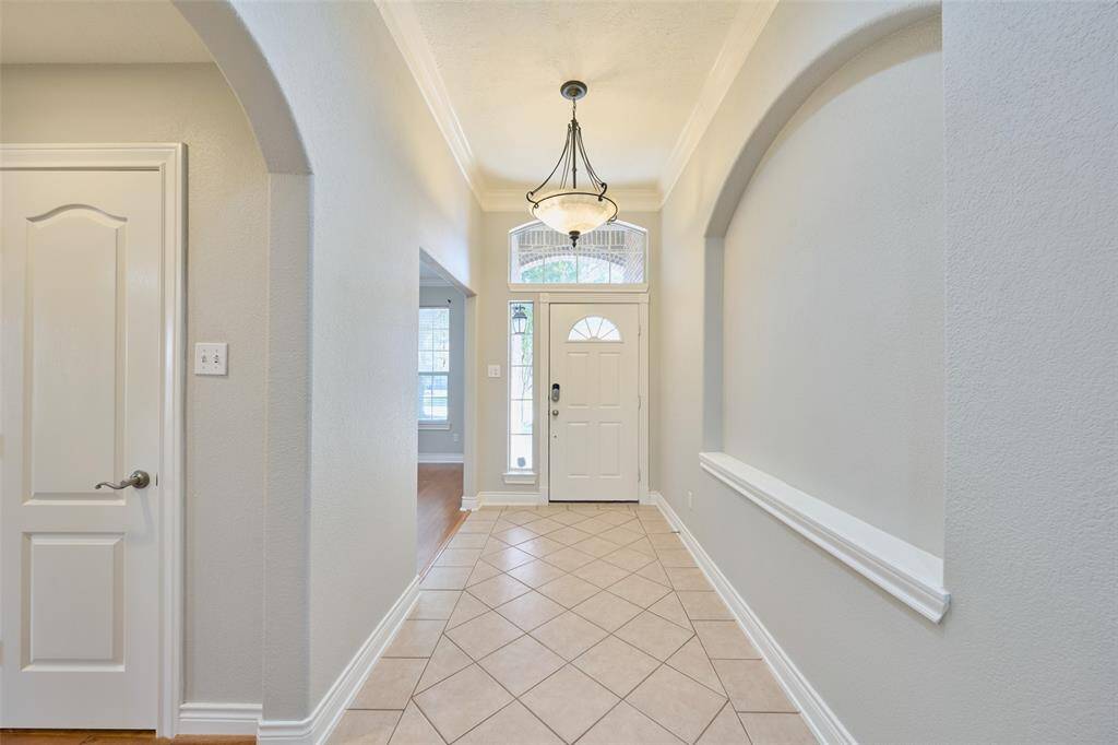 Art niches, crown molding, designer paint, tiled floors in entry & wet areas , hardwood floors in office, halls and living room  & carpet in bedrooms only.