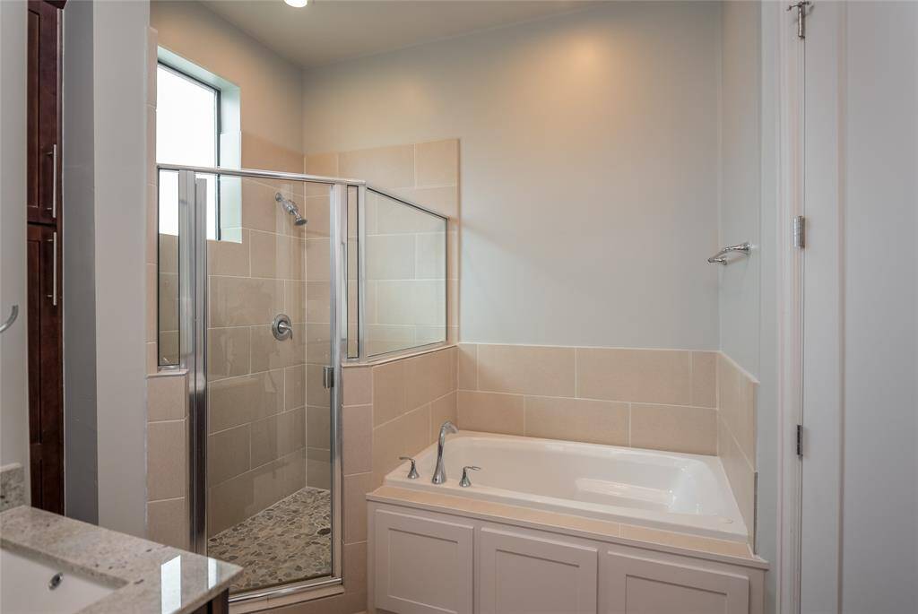 Primary bath with separate shower and soaking tub.