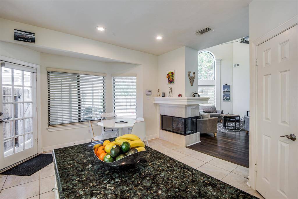 Directly across from the kitchen island is a spacious walk-in pantry. From this angle, you can also see how the kitchen and breakfast room seamlessly flow into the family room.