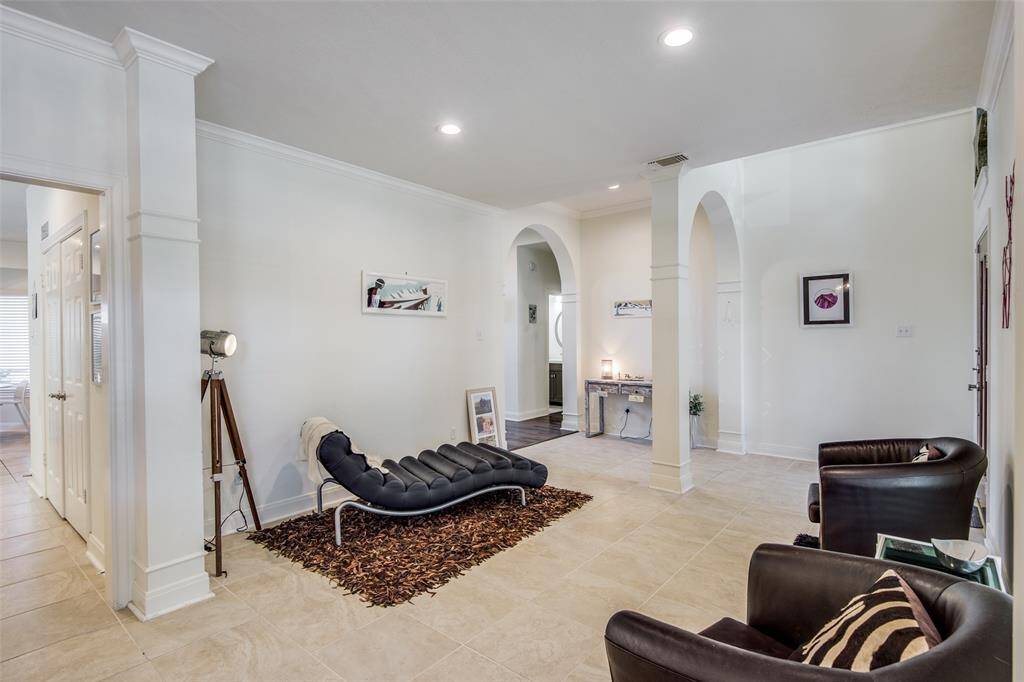 From this angle, you can see the powder room to the right of the foyer as well as the hallway the leads you from the dining area into the kitchen and breakfast room. Across from the powder room is the primary bedroom suite.