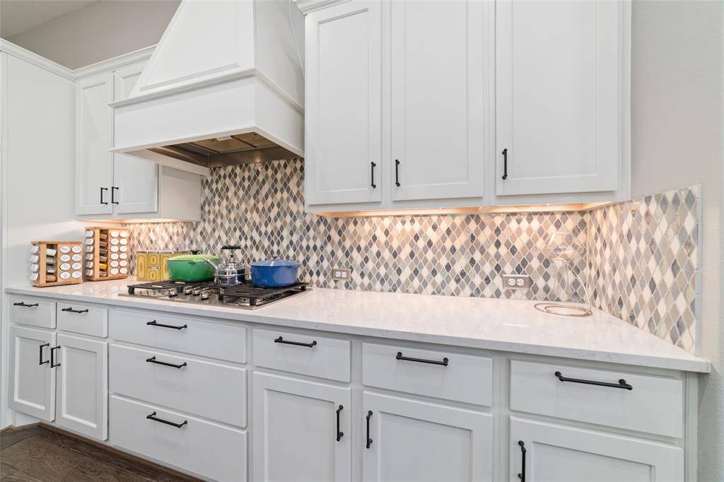 Elegant under cabinet lighting througout, with Restoration Hardware cabinet hardware added for that touch of sophistication and functionality.