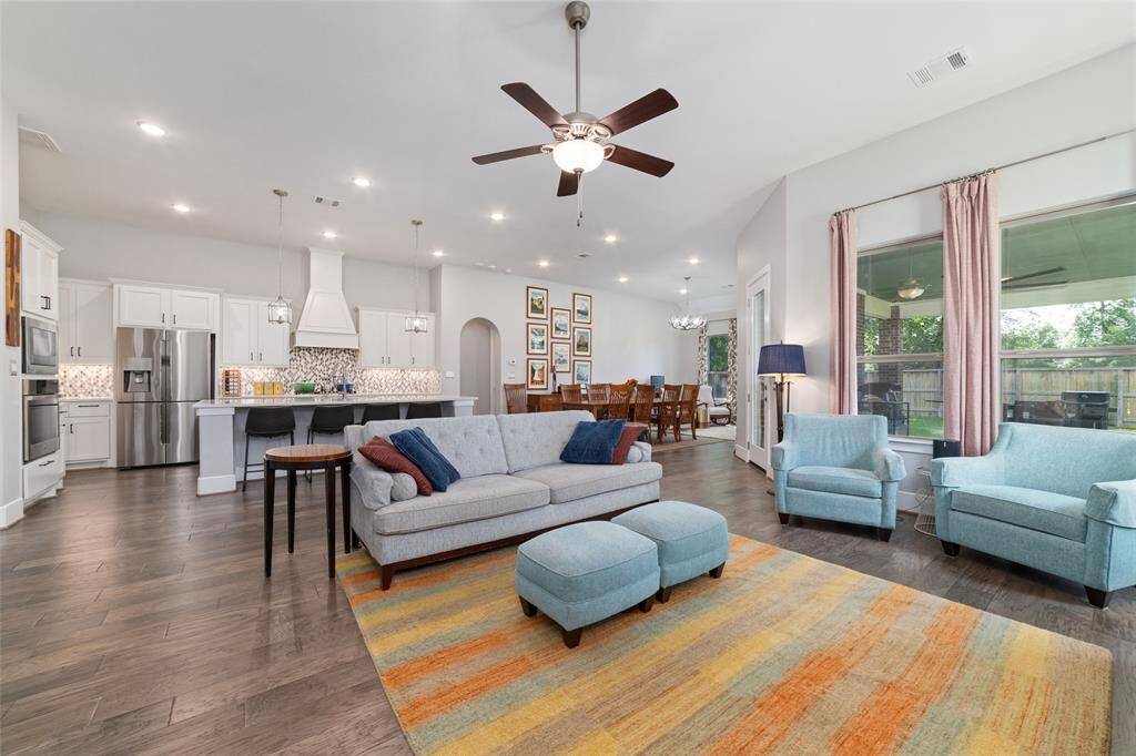 Expansive windows throughout flood the space with natural light, while the neutral palette and stylish finishes enhance the home’s bright, airy feel. From the custom light fixtures to the beautifully coordinated engineered wood flooring, every detail reflects thoughtful design and timeless appeal.
