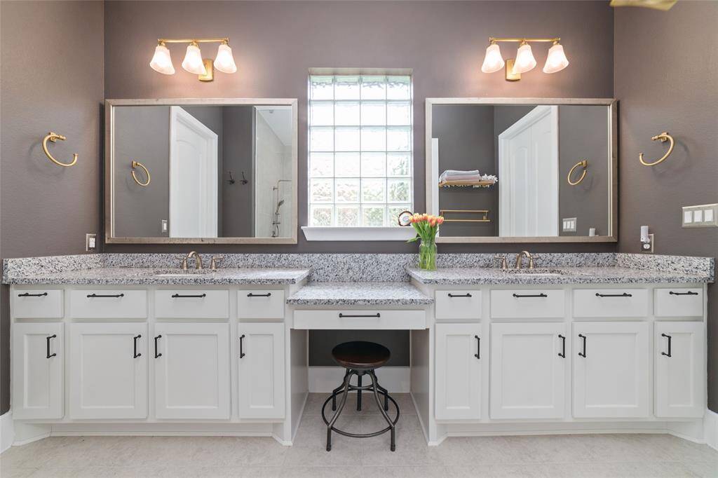Extended double vanity with sitting nook.
