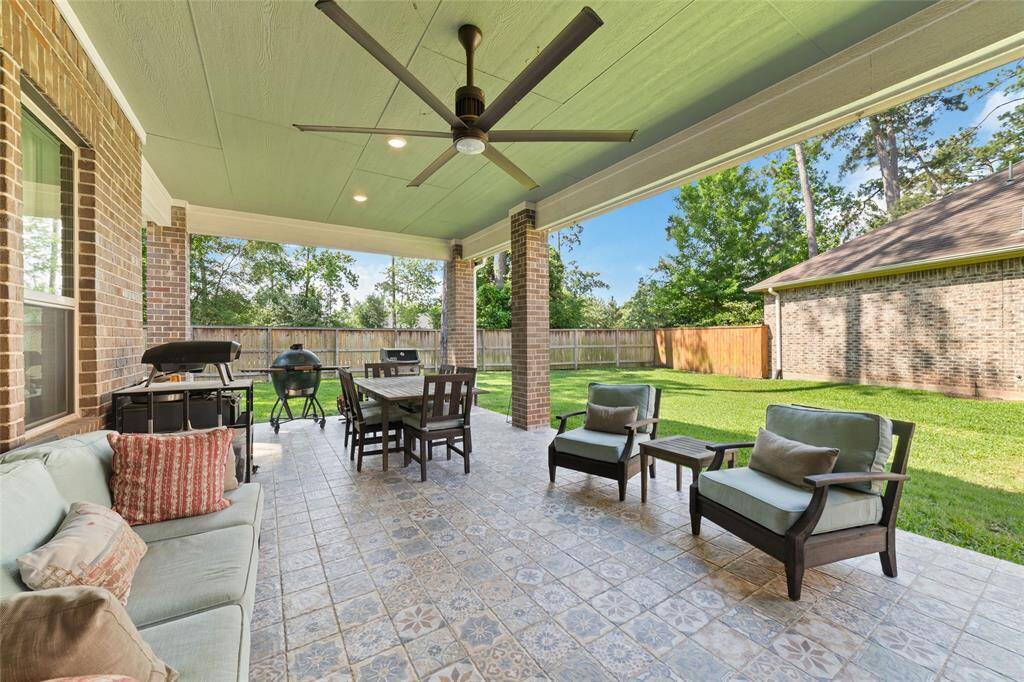 The living space continues outside on this extended covered patio, complete with custom tiling, a "Big Ass" fan and ceiling paint.
