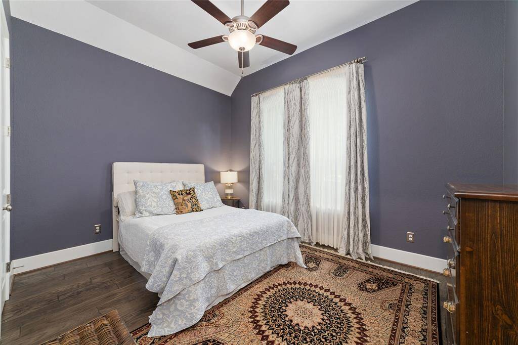 First guest bedroom located at the right of the grand hallway. Beautiful designer paint and window coverings, , and engineered hardwood flooring throughout.