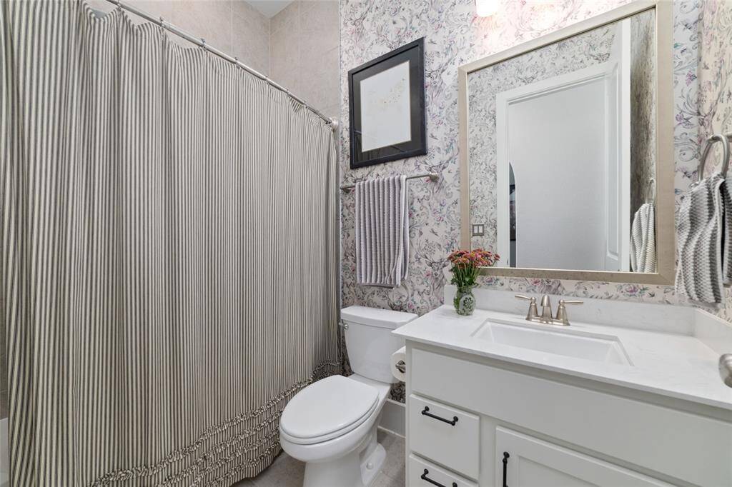 Graham & Brown wallpaper was installed giving this bathroom an elevated look.