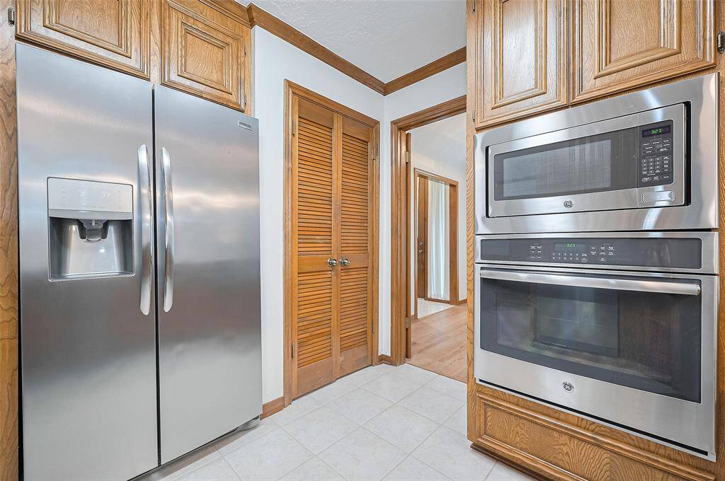 Behind a pair of louvered doors, you’ll find a walk-in pantry offering excellent storage space for dry goods, small appliances, and kitchen essentials.