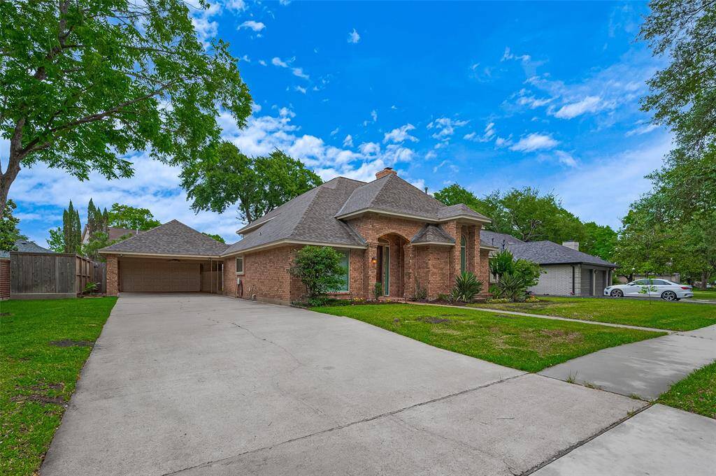 Spacious and functional, this home features a true 2-car wide driveway leading to a detached garage with porte-cochere. The extended drive continues to the rear of the property—ideal for multiple drivers or extra parking when entertaining. The 2023 roof offers energy efficiency, enhanced curb appeal, and long-term protection. Plus, insurance companies often favor newer roofs, potentially lowering premiums.