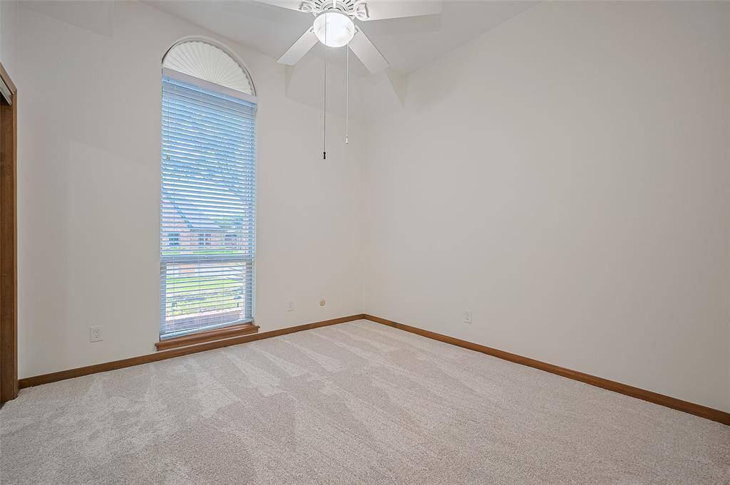 From the living room, a hallway leads to 3 of the 4 bedrooms. Bedroom #3 features a tall ceiling and a large window overlooking the front yard, with a ceiling fan for added comfort. The home is equipped with energy-efficient double-pane windows throughout, installed in 2018. Double-pane windows help reduce energy costs by improving insulation, keeping the home cooler in the summer and warmer in the winter, while also reducing outside noise.