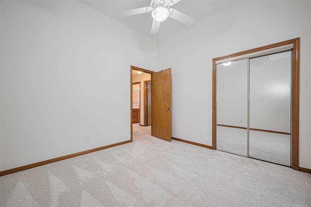 Bedroom #3, measuring 10'11" x 10'11", offers good wall space for arranging furniture. It features mirrored sliding glass closet doors, adding a touch of elegance. The carpet throughout the 1st floor was replaced in 2025, providing a fresh, updated look to the room.