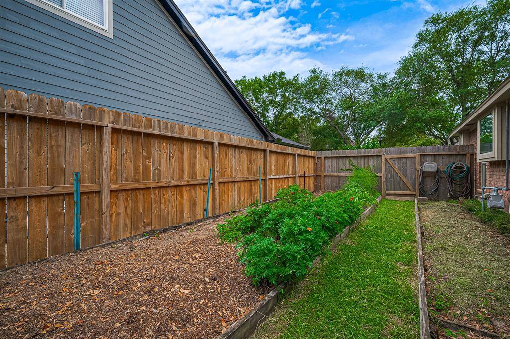 Do you love fresh vegetables and produce? This home features its own dedicated, fenced-off garden area—perfect for growing seasonal vegetables, herbs, or flowers right in your own backyard. The fencing helps keep pets, like the family dog, from digging, ensuring your plants stay safe and thriving. Whether you're a seasoned gardener or just starting out, this space offers endless possibilities for a sustainable, homegrown lifestyle.