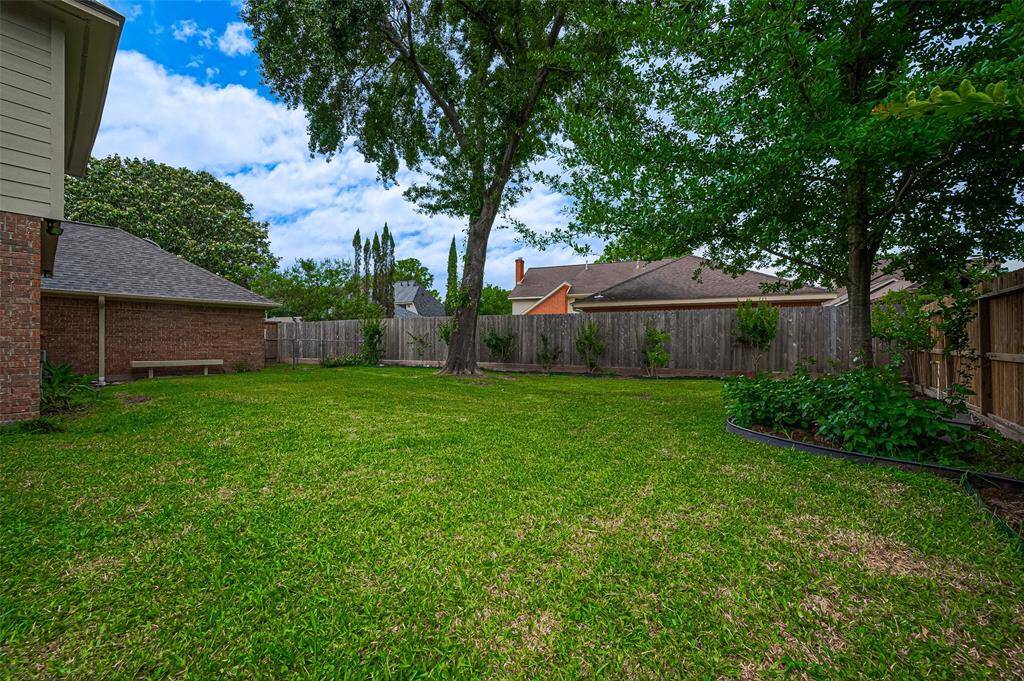 Both the front and backyards are equipped with a full sprinkler system, ensuring your lawn stays lush and green year-round. The home also features gutters and two area drains that effectively direct water off the lot, offering peace of mind with drainage. This home has never flooded. Additionally, there's a fenced area behind the garage with a storage shed for extra convenience. The entire yard is fully fenced with a wood privacy fence, recently replaced in 2023, providing both security and privacy.