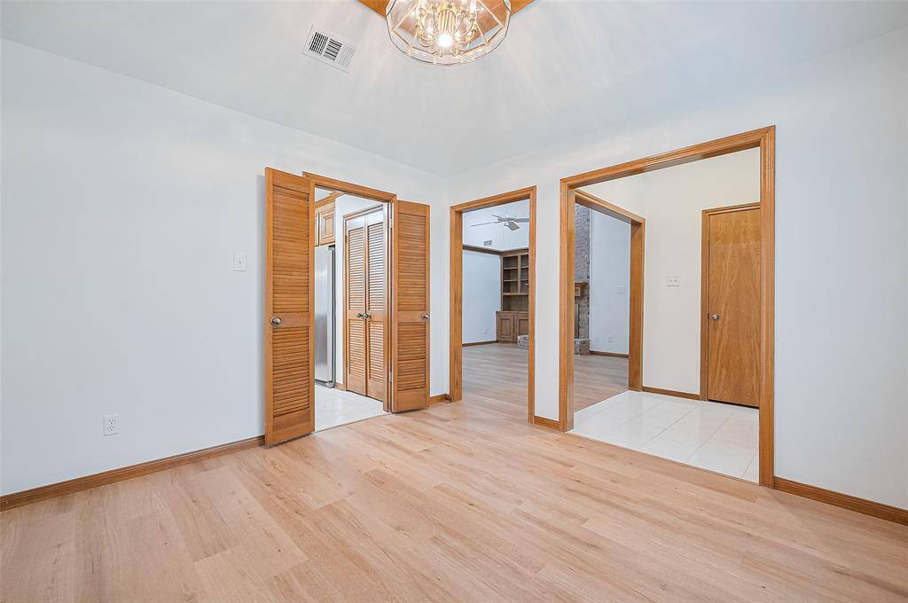 The dining room features louvered doors separating it from the kitchen—ideal for entertaining with flexible flow. Depending on your family's needs, doors could be added to easily convert the space into a home office or study, offering privacy and sound control for conference calls or Zoom meetings.