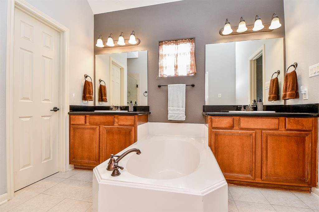 Large soaking tub in the center of the suite. View from the 2nd walk-in closet that houses the surround sound system.