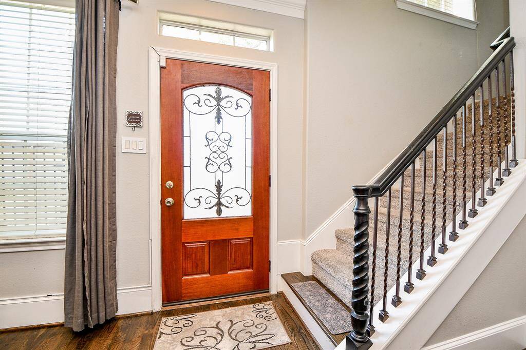 Inviting entry with leaded glass door.