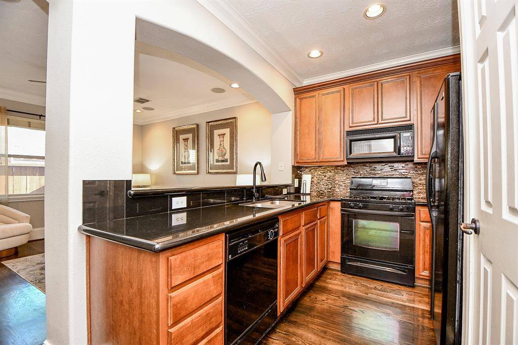 Gully kitchen features granite counters, gas range, and refrigerator stays.
