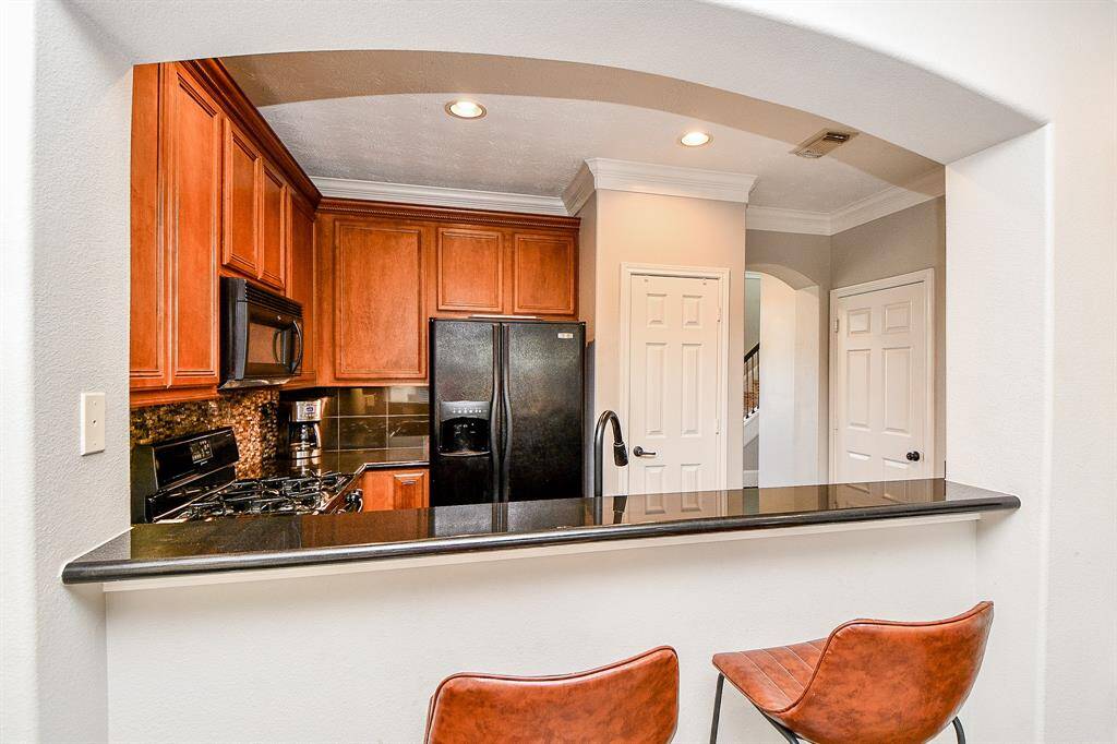 The kitchen bar is a wonderful place to gather.
