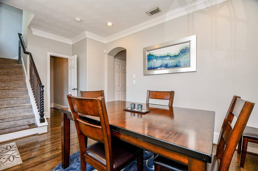 Another view of Formal Dining Room. (Open door-guest bathroom and Garage door is under the arched door way.