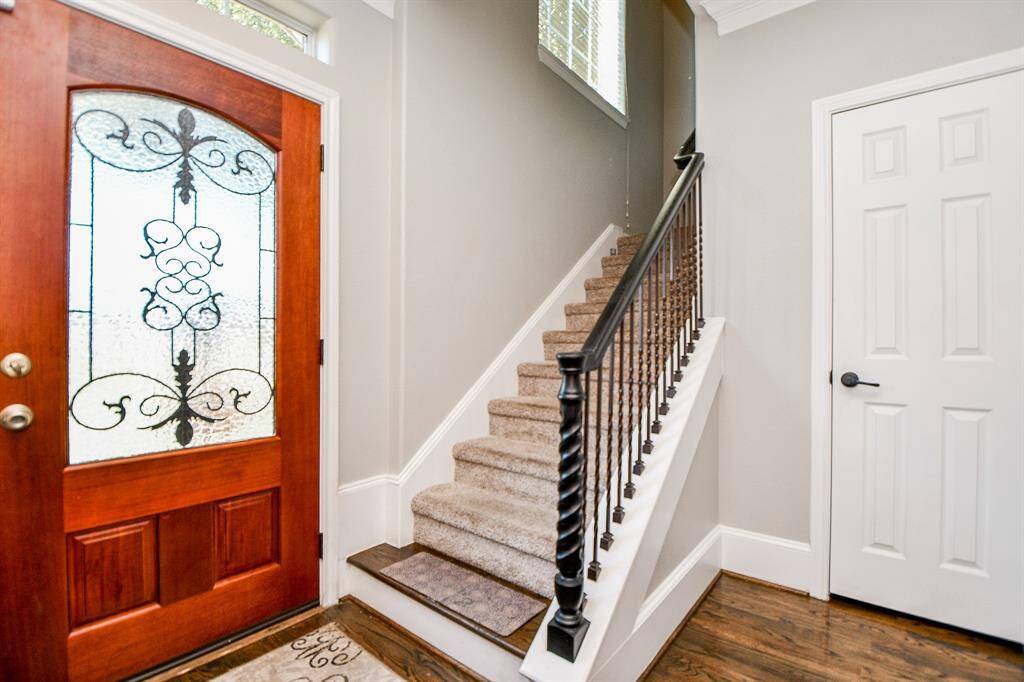 Wrought Iron stairwell leads to flex area and two bedrooms.