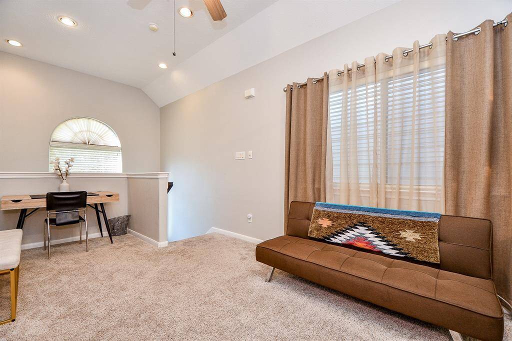 Nice inviting Flex space staged with sofa and office desk.