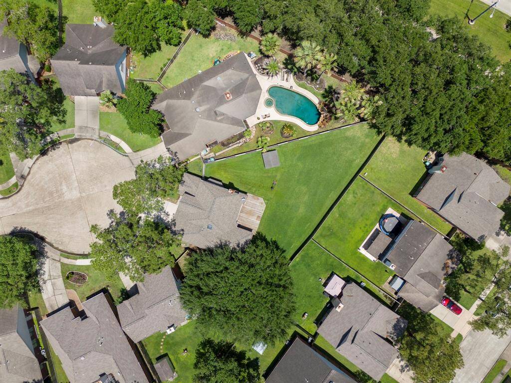 This aerial view highlights the expansive backyard of the property.