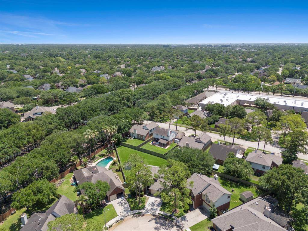 This aerial view showcases a serene suburban neighborhood with lush greenery. Bay Glen is a peaceful and well-maintained subdivision, ideal for family living.