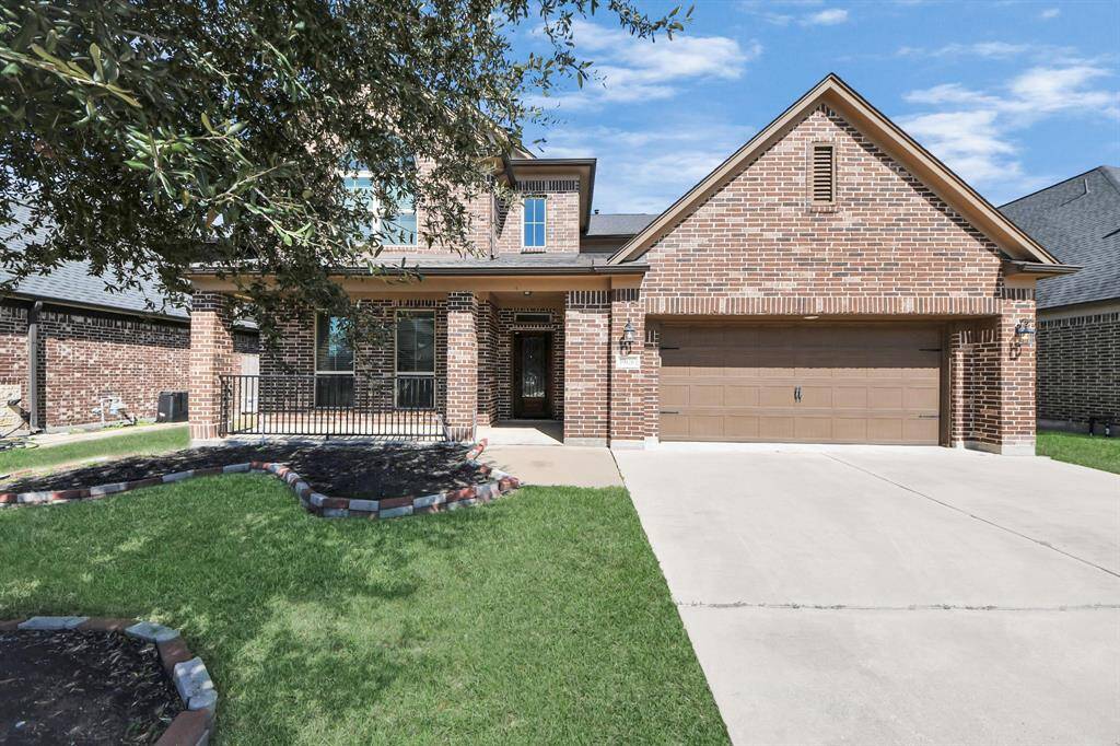 This charming brick home features a two-car garage and a welcoming front porch. The manicured lawn and landscaping enhance its curb appeal, while large windows promise ample natural light inside. Ideal for a family seeking comfort and style.