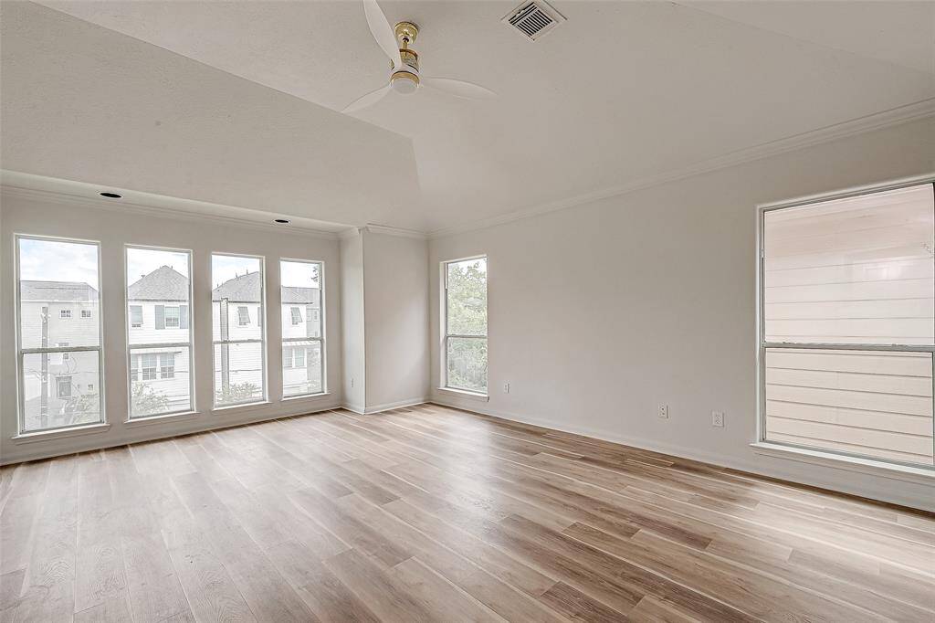 Experience ultimate relaxation in this spacious master retreat, featuring abundant natural light and sleek floors.
