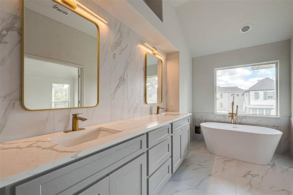 Experience luxury in the newly remodeled master bath featuring a stylish double vanity.