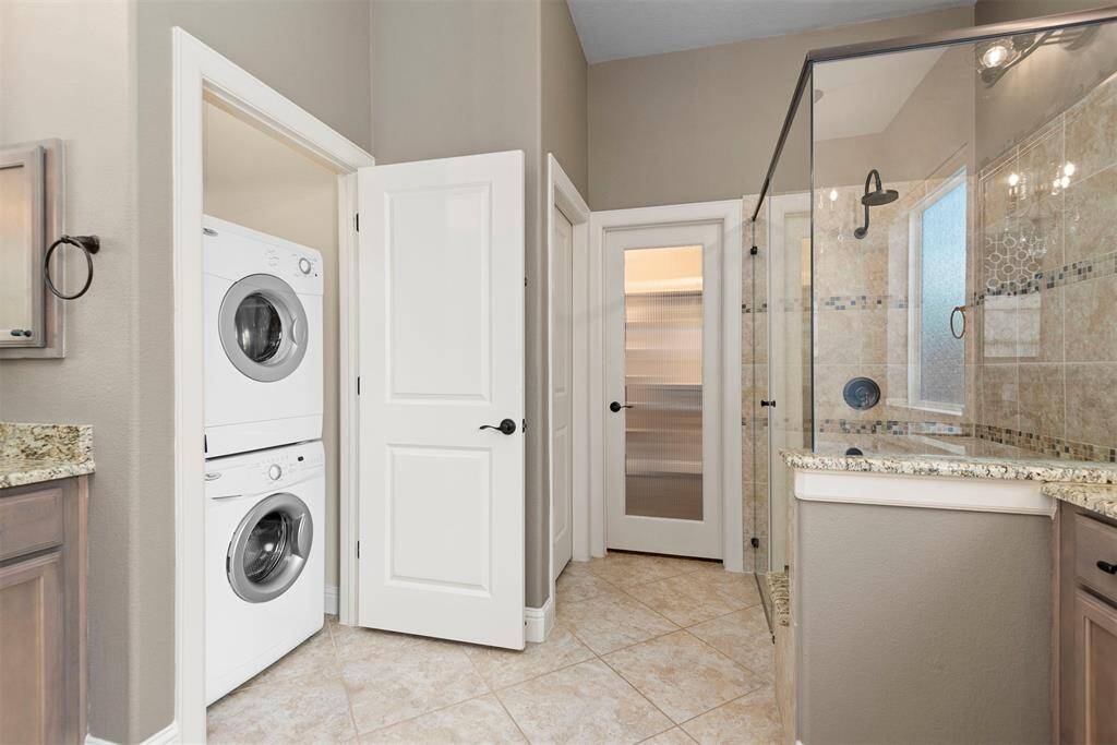 Laundry closet in primary ensuite. There is a 2nd laundry room upstairs.