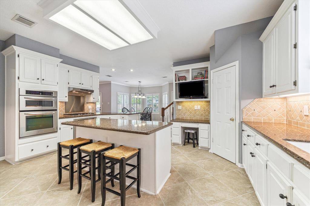 Kitchen features tons of counter space, double ovens, 2 large pantries and more!