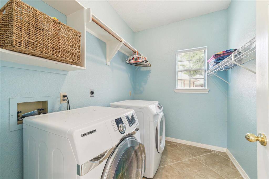 Large laundry room offers ample storage