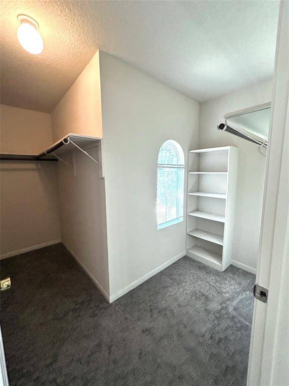 Primary bedroom walk in closet. Closet 1 of 2 in Primary bedroom.