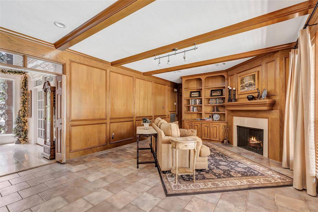 Another view of the family room with gas log fire place and built in shelves.