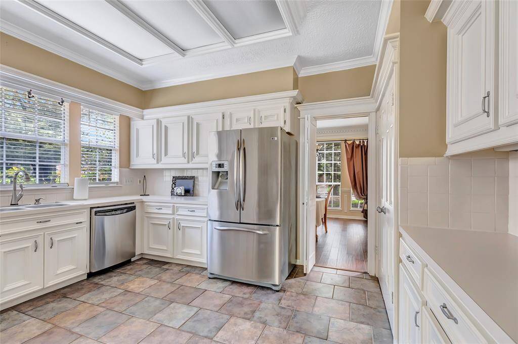 A spacious kitchen with the door leading to the dining room.