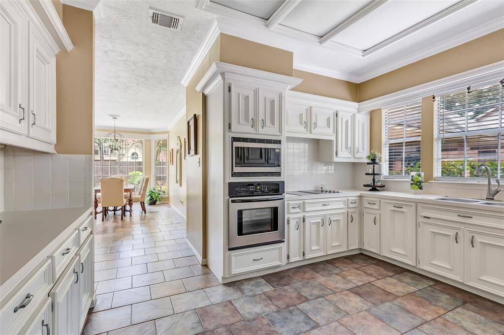 Another view of the spacious kitchen, looking towards the Breakfast room! Notice the stainless appliances and the kitchen sink windows!