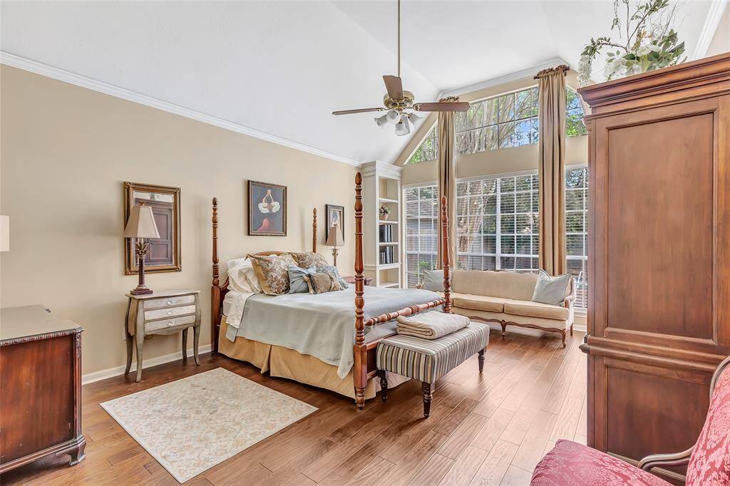 The expanxsive Primary bedroom is just off the family room with a large wall of windows and views of the pool.