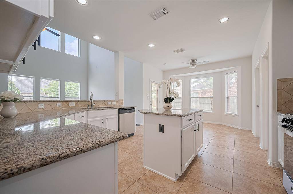 Bathed in natural light, this kitchen is as cheerful as it is functional—perfect for morning routines or evening gatherings.
