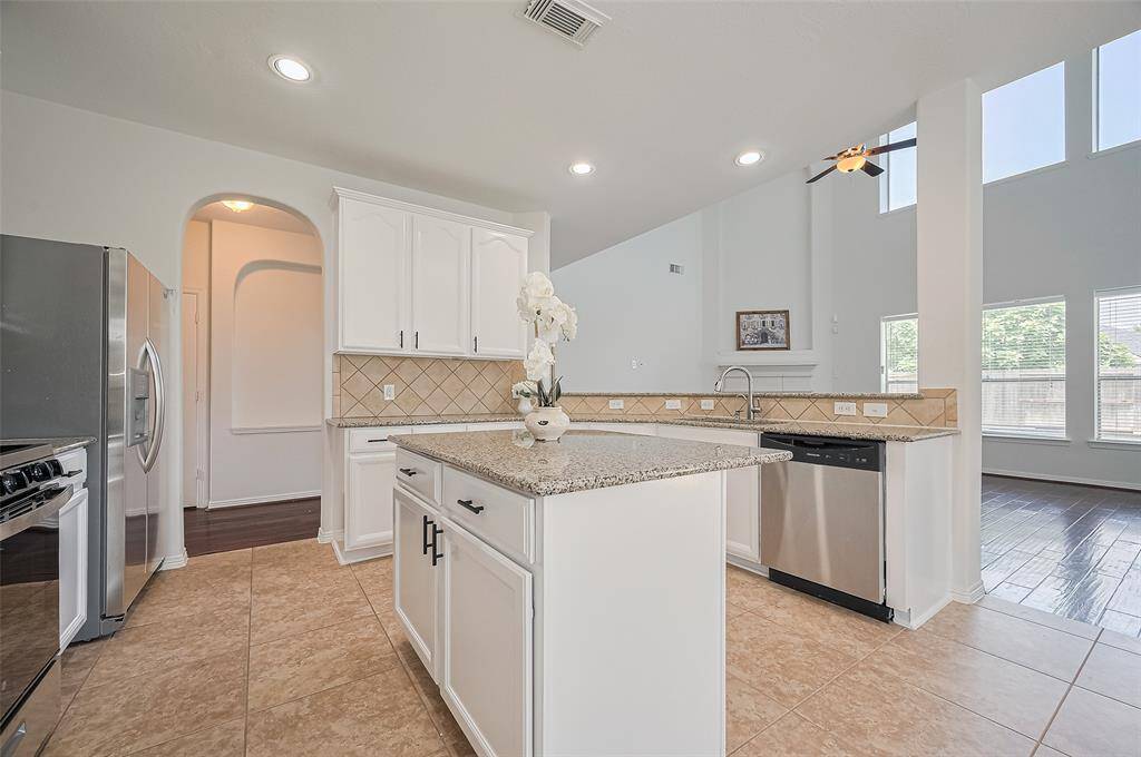 A beautifully refreshed kitchen with painted cabinets, new stainless appliances, and a layout built for connection.