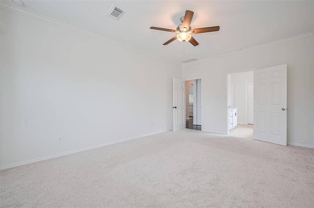 Primary Bedroom on the first floor is spacious and serene, features soft natural light and soothing tones for ultimate relaxation.