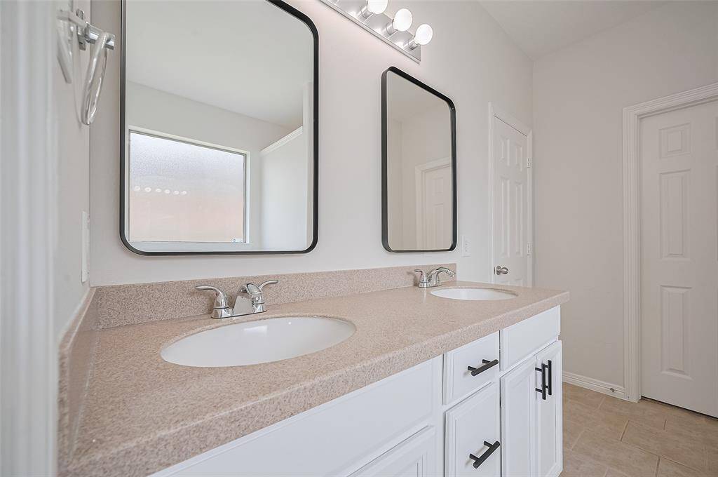 Dual vanities with elegant quartz counters.