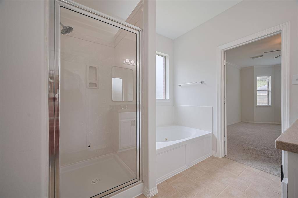 Soaking tub and separate shower for spa vibes.