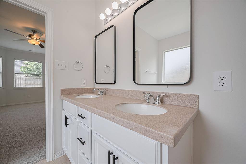 Backlit mirror adds a modern glow to the vanity area.