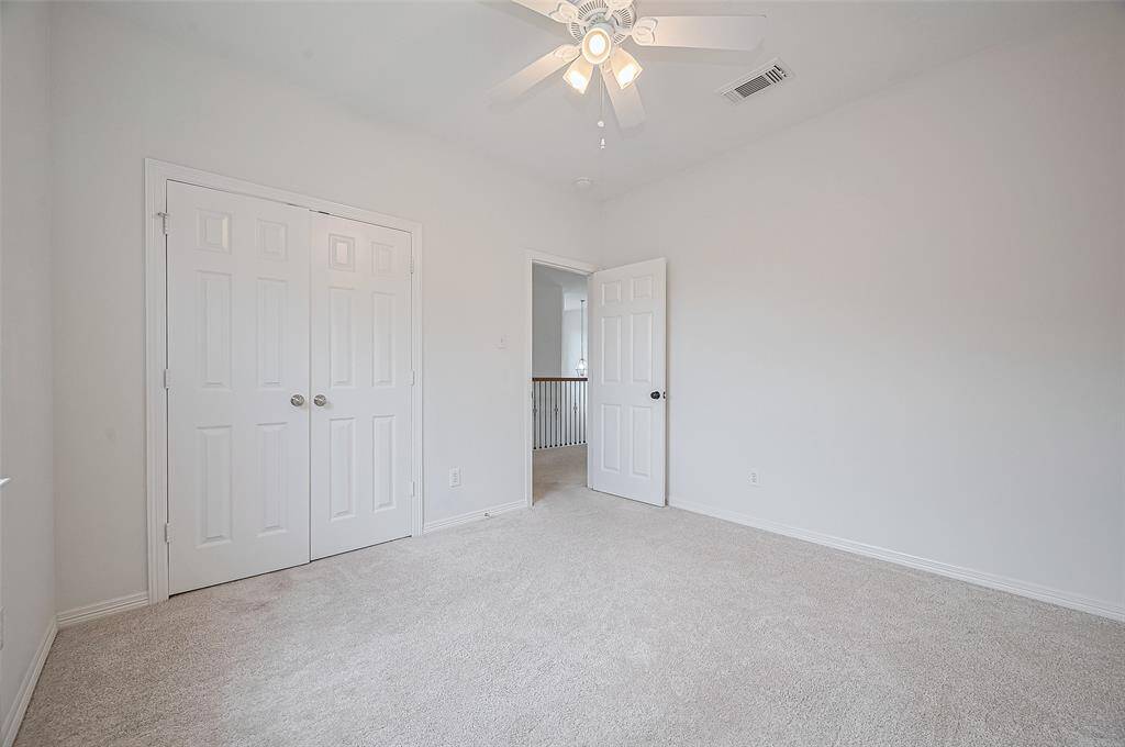 Tray ceilings, elegant trim, and plush carpeting create a luxurious yet cozy atmosphere.