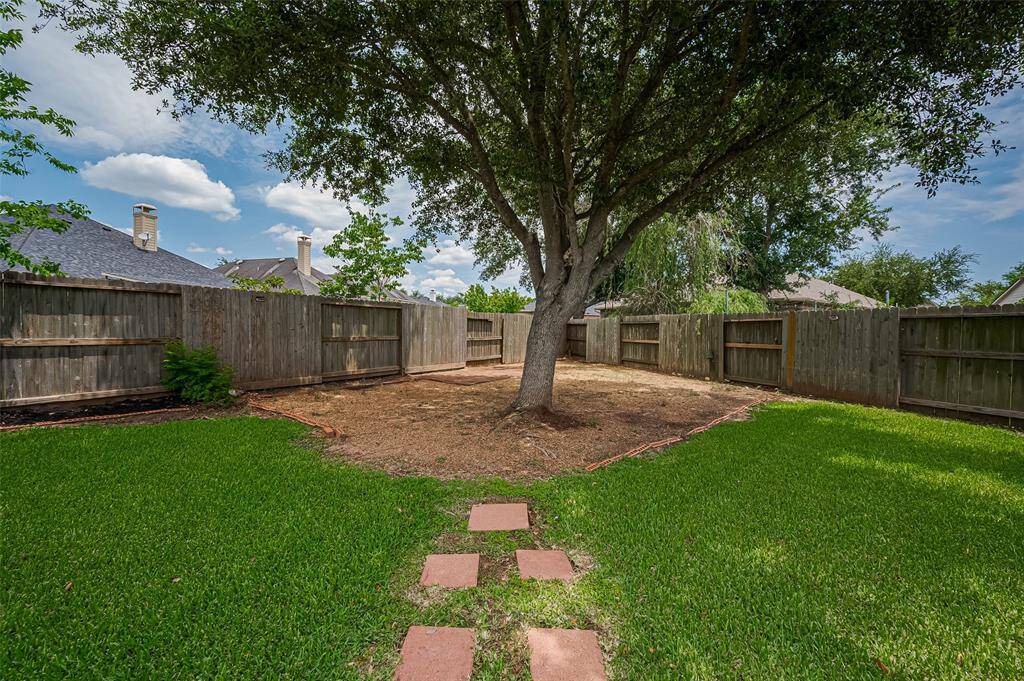 Tall, trimmed trees and newer fencing create a sense of seclusion in your own personal oasis.